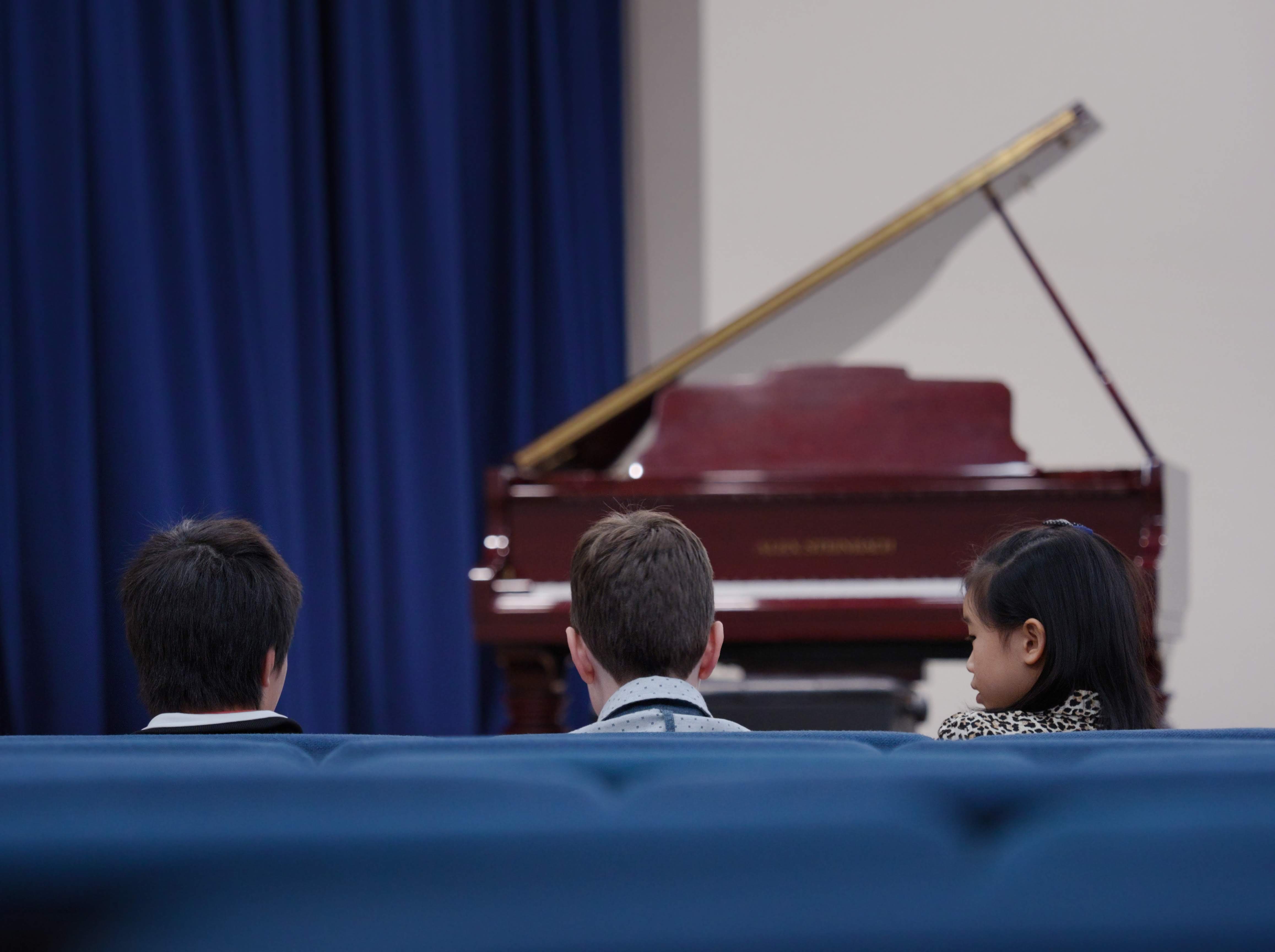 WGE Pianoforte Day 2 Three Children Wait for Their Turn to Perform